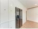 Stainless steel refrigerator stands next to white cabinets in the kitchen area at 1016 38Th W St, Bradenton, FL 34205