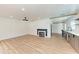 Open-concept living area features wood floors, fireplace, updated kitchen and modern lighting for a comfortable living space at 1016 38Th W St, Bradenton, FL 34205