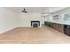 Bright living room offers wood floors, recessed lights, a fireplace, and built-in cabinets at 1016 38Th W St, Bradenton, FL 34205