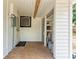 An enclosed porch featuring tile floors, white wood walls, and storage space at 1016 38Th W St, Bradenton, FL 34205