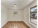 A minimalist room featuring hardwood floors, crisp white walls, and natural light at 1016 38Th W St, Bradenton, FL 34205