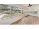 Bright sunroom with wood floors and an abundance of windows, creating a seamless connection to the outdoors at 1016 38Th W St, Bradenton, FL 34205