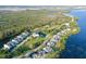 An aerial view showing the community along the water, with a nature preserve as a backdrop at 111 Tidy Island Blvd # 111, Bradenton, FL 34210