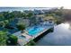 Stunning aerial view of community pool, clubhouse, lush landscaping and Gulf of Mexico backdrop at 111 Tidy Island Blvd # 111, Bradenton, FL 34210