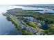 Captivating aerial shot of coastal homes nestled amid greenery and a calm bay, in a prime location at 111 Tidy Island Blvd # 111, Bradenton, FL 34210