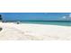A beautiful view of the beach with clear blue water, white sand, and people enjoying the scenery at 111 Tidy Island Blvd # 111, Bradenton, FL 34210