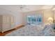Bedroom with view of the outside, ceiling fan, and dresser with drawers at 111 Tidy Island Blvd # 111, Bradenton, FL 34210