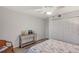 Bright bedroom featuring white ceiling fan, neutral walls, light wood floors, and sliding closet doors at 111 Tidy Island Blvd # 111, Bradenton, FL 34210