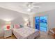 A primary bedroom with slider to patio, ceiling fan, and matching night stands at 111 Tidy Island Blvd # 111, Bradenton, FL 34210