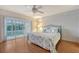 Comfortable bedroom with wood floors and access to a screened-in porch at 111 Tidy Island Blvd # 111, Bradenton, FL 34210