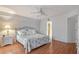 Bedroom with wood floors, ceiling fan, walk in closet and a bed with decorative pillows at 111 Tidy Island Blvd # 111, Bradenton, FL 34210