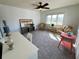 Bonus room featuring a ceiling fan, neutral colored carpet, comfortable seating and bright natural light at 111 Tidy Island Blvd # 111, Bradenton, FL 34210