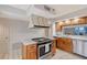 Functional kitchen with a center island cooktop, ample counter space, and updated appliances for cooking ease at 111 Tidy Island Blvd # 111, Bradenton, FL 34210