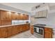 Well-equipped kitchen featuring wood cabinets, granite countertops, and modern appliances for efficient cooking at 111 Tidy Island Blvd # 111, Bradenton, FL 34210