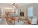 Cozy living room featuring a fireplace, neutral armchairs, and hardwood floors leading to the dining area at 111 Tidy Island Blvd # 111, Bradenton, FL 34210