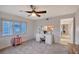 Bright room with a desk, fan, view from the window, and a pass-through to the kitchen at 111 Tidy Island Blvd # 111, Bradenton, FL 34210