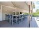 Covered outdoor bar with ample seating, a built-in TV, and lush landscaping at 111 Tidy Island Blvd # 111, Bradenton, FL 34210