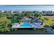 Community pool with lounge chairs, dining area, and lush landscaping at 111 Tidy Island Blvd # 111, Bradenton, FL 34210
