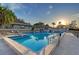 Stunning community pool featuring a sundeck, lounge chairs and multiple buildings, perfect for relaxation and recreation at 111 Tidy Island Blvd # 111, Bradenton, FL 34210