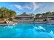Beautifully maintained community pool surrounded by lush greenery and comfortable lounge seating at 111 Tidy Island Blvd # 111, Bradenton, FL 34210