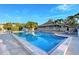 Tranquil community pool with a view of the clubhouse and palm trees against a clear sky at 111 Tidy Island Blvd # 111, Bradenton, FL 34210