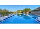Community pool surrounded by tropical vegetation and ample lounge seating with water views at 111 Tidy Island Blvd # 111, Bradenton, FL 34210