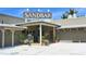 Exterior view of the Sandbar restaurant featuring covered entry and decorative potted plants at 111 Tidy Island Blvd # 111, Bradenton, FL 34210
