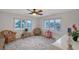 Cozy sitting area bathed in natural light, featuring wicker chairs and neutral carpet for serene relaxation at 111 Tidy Island Blvd # 111, Bradenton, FL 34210