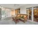 Bright and airy sunroom features comfortable wicker furniture, offering serene water views and a relaxing atmosphere at 111 Tidy Island Blvd # 111, Bradenton, FL 34210