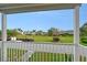 Balcony view overlooking the lush green lawn, mature trees, and community homes in this beautiful neighborhood at 111 Tidy Island Blvd # 111, Bradenton, FL 34210