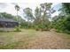Expansive backyard with mature trees, and native landscaping provides a serene setting off of the screened lanai at 1143 131St E St, Bradenton, FL 34212