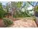 Backyard gazebo with fire pit and bench seating, set amongst mature trees and natural landscaping at 1143 131St E St, Bradenton, FL 34212