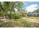 Lush backyard features mature trees, a charming gazebo, and a serene screened-in porch at 1143 131St E St, Bradenton, FL 34212