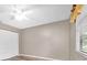 This bedroom features a ceiling fan, closet, and window at 1143 131St E St, Bradenton, FL 34212