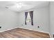 This bedroom features gray walls, wood floors, and a window at 1143 131St E St, Bradenton, FL 34212