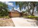 Home with a spacious driveway, mature landscaping, and a two-car garage, offering ample parking and curb appeal at 1143 131St E St, Bradenton, FL 34212