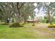 Charming single-story home with attached garage, lush lawn and mature oak trees draped with Spanish moss at 1143 131St E St, Bradenton, FL 34212