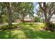Beautiful single-story home with a two car garage, expansive front lawn, and large oak trees draped with Spanish moss at 1143 131St E St, Bradenton, FL 34212