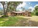 Charming single-story home with well-maintained lawn, mature trees, and inviting curb appeal with a two car garage at 1143 131St E St, Bradenton, FL 34212