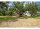 Charming single-story home nestled amidst mature trees and a sprawling front yard at 1143 131St E St, Bradenton, FL 34212