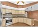 Well-equipped kitchen with stainless steel appliances, tile backsplash, and wood-look flooring at 1143 131St E St, Bradenton, FL 34212