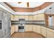 Well-lit kitchen features stainless steel appliances, wooden cabinets, and beautiful backsplash at 1143 131St E St, Bradenton, FL 34212