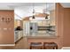 Bright kitchen boasts stainless steel refrigerator and modern design with bar seating at 1143 131St E St, Bradenton, FL 34212