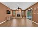 Spacious living room with brick fireplace and sliding door access to pool area at 1143 131St E St, Bradenton, FL 34212