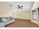 Spacious living room with a high ceiling, modern fan, and tiled floors at 1143 131St E St, Bradenton, FL 34212