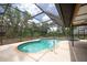 Enjoy the pool and spa in a large screened in enclosure with lush greenery views at 1143 131St E St, Bradenton, FL 34212