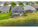 Aerial view of home with screened in pool and outdoor entertaining space overlooking pond at 12330 Halfmoon Lake Ter, Bradenton, FL 34211