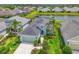 Aerial view of home showcasing lush landscaping, a lake, and a well-maintained yard at 12330 Halfmoon Lake Ter, Bradenton, FL 34211