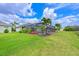 Backyard featuring a screened-in lanai, pool, and lush green lawn at 12330 Halfmoon Lake Ter, Bradenton, FL 34211