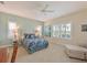 Bright bedroom features a blue patterned bedspread, and plantation shutters filtering natural light at 12330 Halfmoon Lake Ter, Bradenton, FL 34211